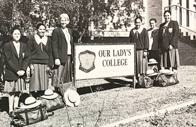 historical photo of principal with senior students at front of college