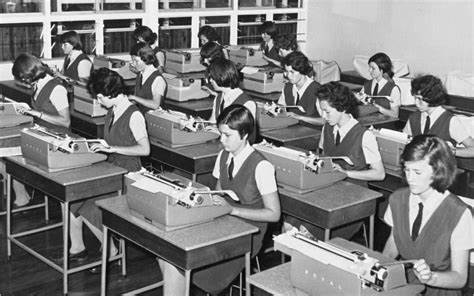 Historical photo of Our Ladys College students typing on typewriters. Estimated to be taken late in the 1960s