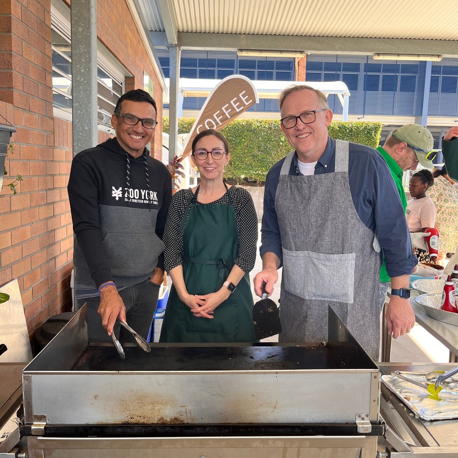 groups of parents working on a BBQ