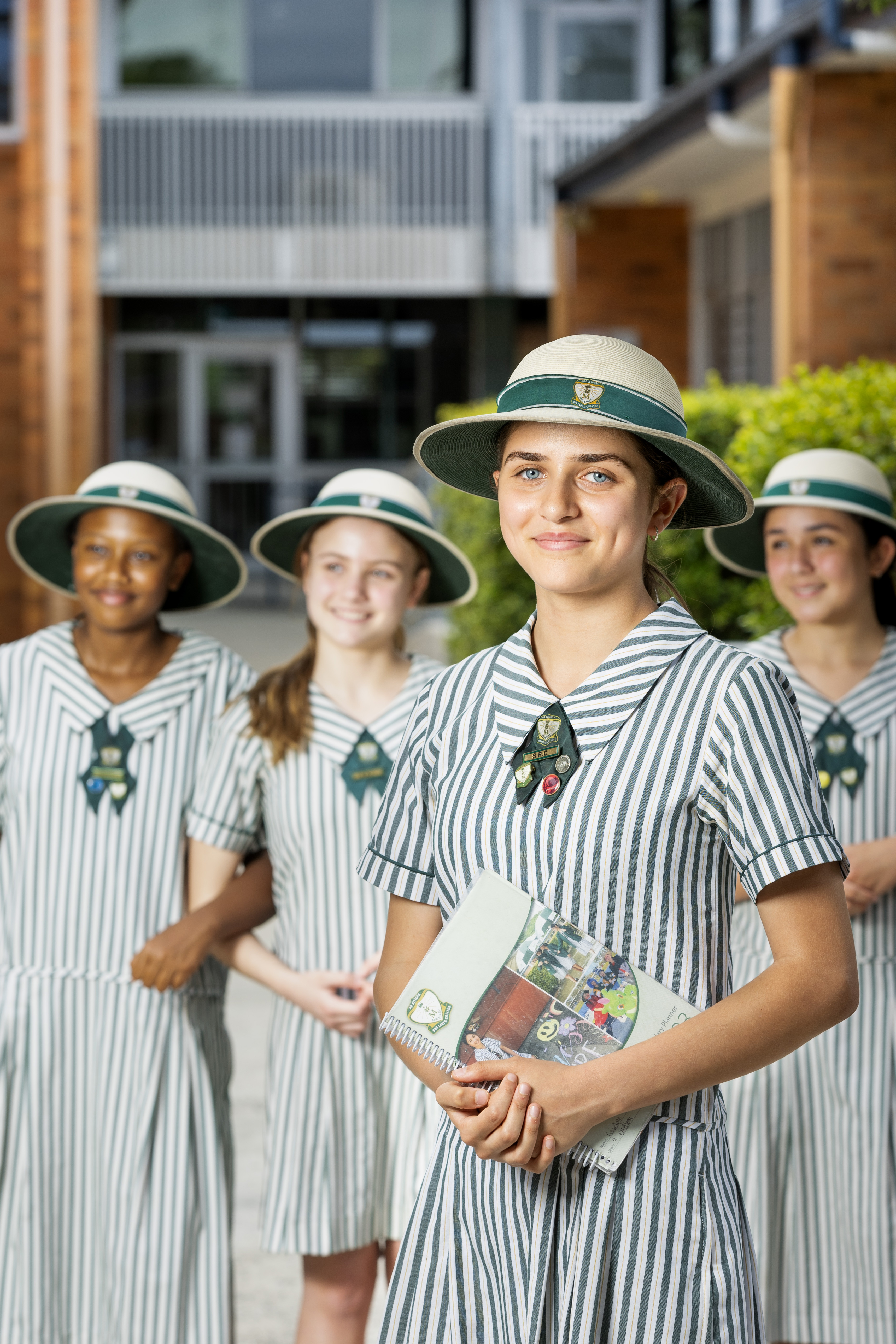 group of four senior students smiling at the camera